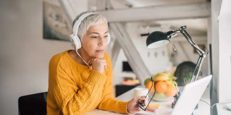 problem-solving skills, woman with headset in front of laptop