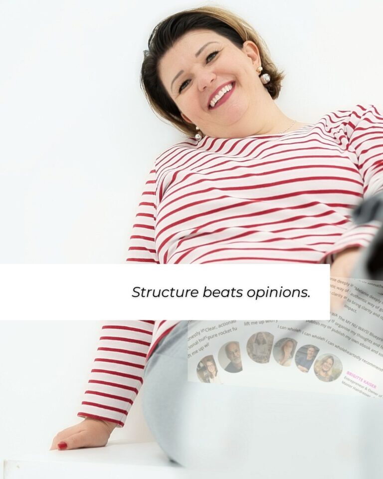 Entrepreneur reflecting while working at a desk, representing the shift from trial-and-error to building clear business systems. business community