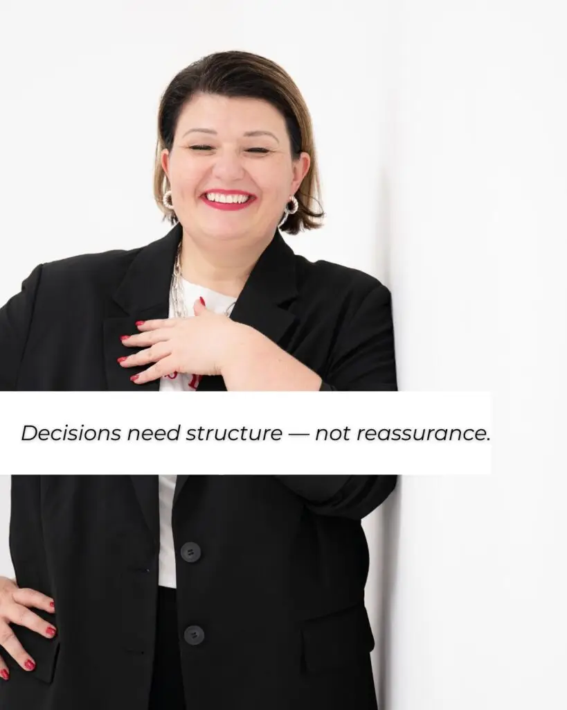 Text overlay reading “Decisions need structure — not reassurance” on a professional business image. business community
